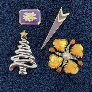 Set of 4 costume jewelry pins.